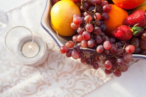 a bowl of fruit on a table with a candle at Medieval Dreams Villa in Rhodes Town