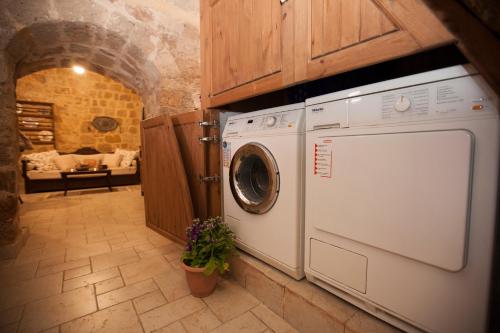 a washer and dryer in a kitchen with a living room at Medieval Dreams Villa in Rhodes Town