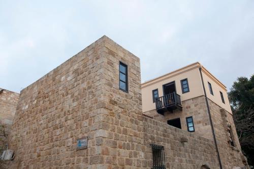 a building with a balcony on top of a brick wall at Medieval Dreams Villa in Rhodes Town