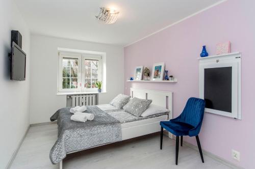 グダニスクにあるRentApart Stare Miastoのベッドルーム1室(ベッド1台、青い椅子付)