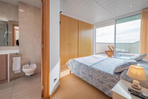 A bed or beds in a room at InSitges Sant Sebastia's Beach