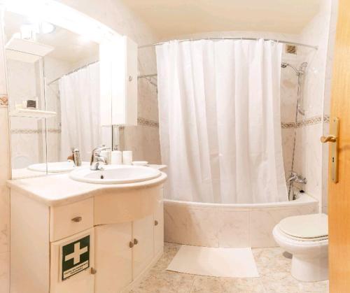 a bathroom with a tub and a sink and a toilet at Marble House in Póvoa de Varzim
