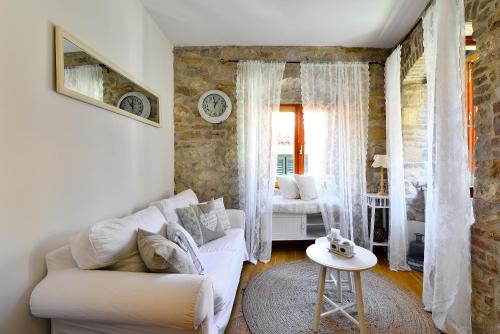 a living room with a white couch and a table at Apartments Toma in Split