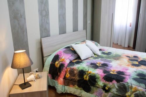 a bedroom with a bed and a table with a lamp at L'Alberata dei Sogni in Frosinone