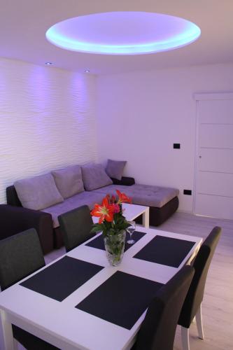 a living room with a table and a couch at Holiday Apartment Lira jacuzzi - sea view- terrace in Mlini