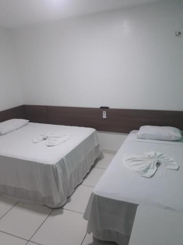 duas camas sentadas uma ao lado da outra num quarto em Pousada Pampa Gaúcho em Teresina