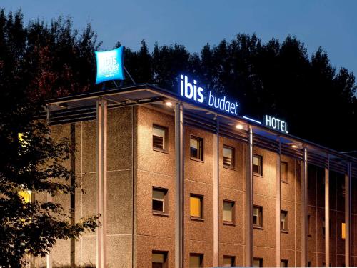 a large building with a clock on the front of it at ibis budget Amsterdam Airport in Badhoevedorp