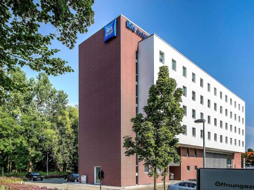 a building with a sign on the side of it at ibis budget Augsburg City in Augsburg