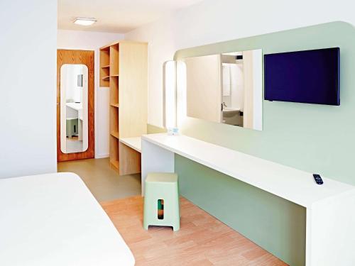 a room with a bed and a mirror at Warrington Motel, J20 M6 Lymm Services in Warrington