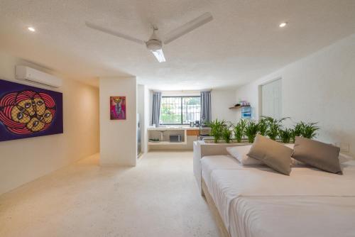 a living room with a white couch and a painting on the wall at Art Studios in Cancún