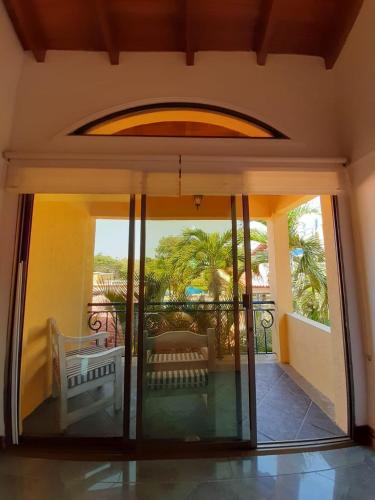 an open door of a house with a balcony at Porto Bello Hotel Boutique in Puerto Colombia