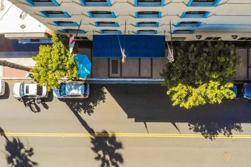 an overhead view of a building with trees and a street at Empress Hotel La Jolla in San Diego