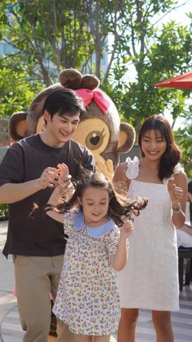 a man and a woman and a little girl in front of a stuffed animal at Amari Pattaya in Pattaya Central