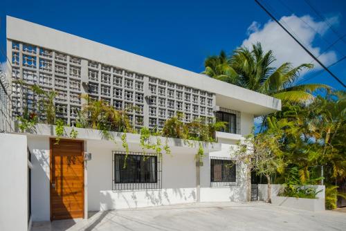 a large white building with a large window at Art Studios Local Acommodation & Art Shop in Cancún