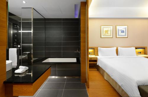 a hotel room with a bed and a shower at Walden Hotel in Yilan City
