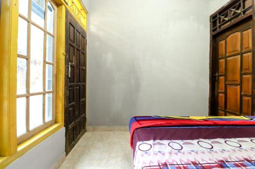 a bedroom with a bed and a window at Jemakir Homestay in Sermo