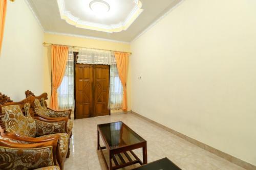 a living room with a couch and a table at Jemakir Homestay in Sermo