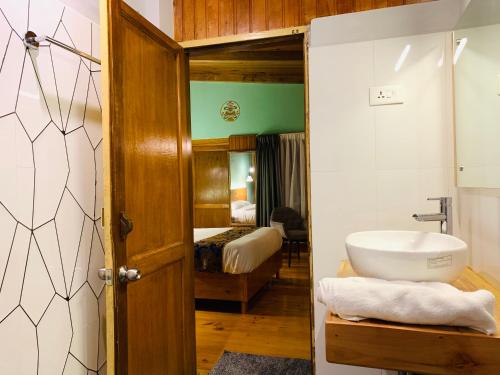 a bathroom with a sink and a toilet in a room at Dzi Pema in Paro