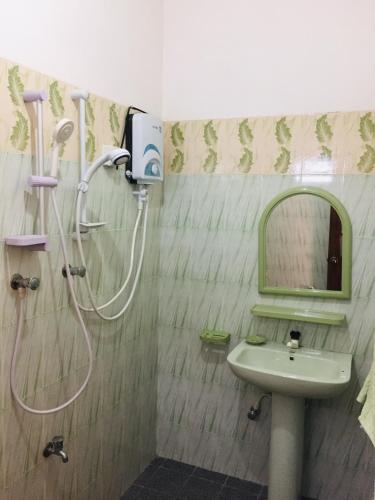 a bathroom with a shower and a sink and a mirror at Diwanka Villa in Unawatuna