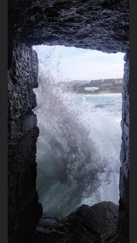 a view of the water from a window in a cave at Hotel Josein in Comillas