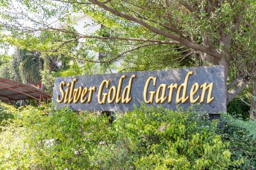 a sign that says silver gold garden in front of trees at Silver Gold Garden, Suvarnabhumi Airport in Lat Krabang