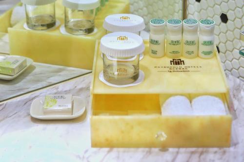 a table with a box of moisturizers and cosmetics at Jinjiang Metropolo Hotel Classic Nanjing Road (East) Shanghai in Shanghai