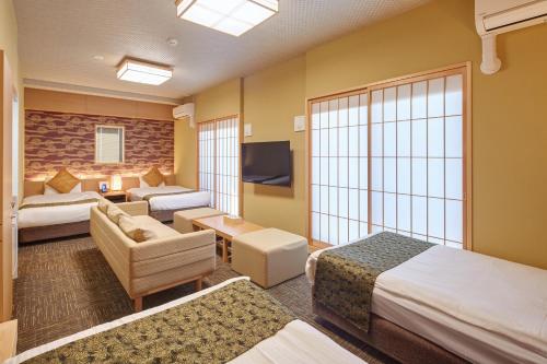 Postel nebo postele na pokoji v ubytování Hotel Amaterrace Nippombashi-higashi