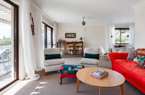 a living room with a red couch and a table at Newport Beach Spacious 2 bedrm apt Casa de Piña in Newport