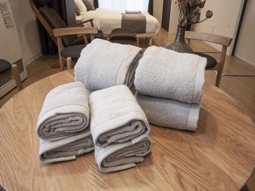 a pile of towels sitting on top of a table at UCHI Susukino 5.7 in Sapporo