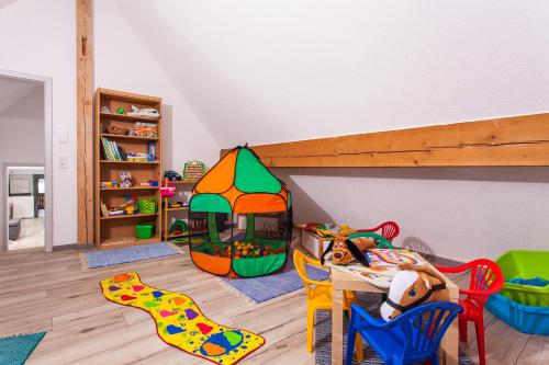 a childs play room with a table and toys at Ferienwohnungen Schwabenhof in Schramberg