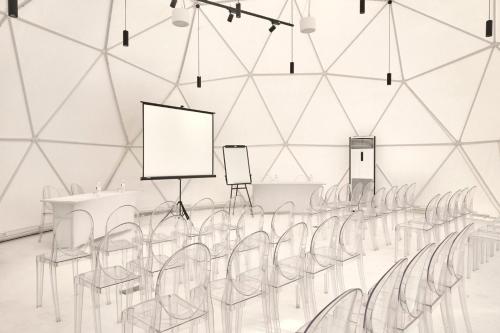 an empty room with chairs and tables and a screen at The ANMON Resort Bintan in Lagoi