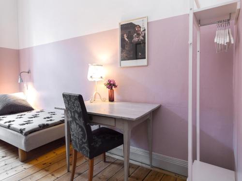 a room with a bed, chair, lamp and a lamp post at Castanea Old Town Hostel in Stockholm