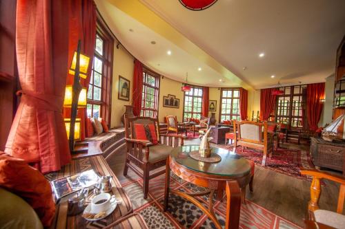 a living room with a lot of furniture and windows at African Tulip in Arusha