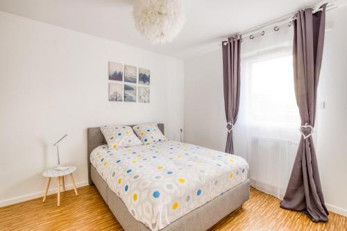 a bedroom with a bed and a window at J-Mo Home - Chessy - Magnifique vue sur le château in Chessy