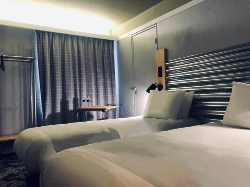 Postel nebo postele na pokoji v ubytování Ibis Styles Bobigny Centre Préfecture