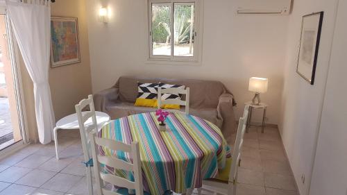 a living room with a table and a couch at Entre Mer et Estérel in Roquebrune-sur-Argens