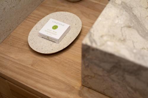 a box of soap sitting on a table next to a stone at Maison Tillot in Dijon