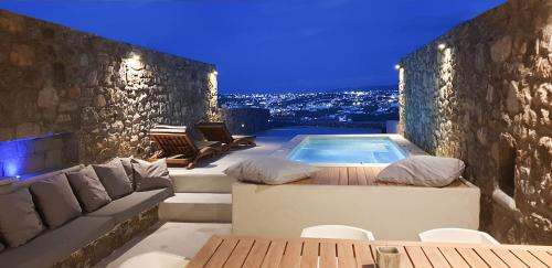 a backyard with a swimming pool and a house at Mykonos Actor’s Villa. 2 BDRs, private mini-pool in Mikonos