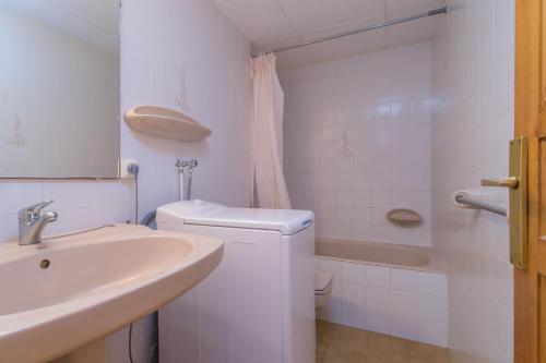 a white bathroom with a sink and a toilet at Ñ-13 CALELLA DE PALAFRUGELL 4 PAX in Calella de Palafrugell