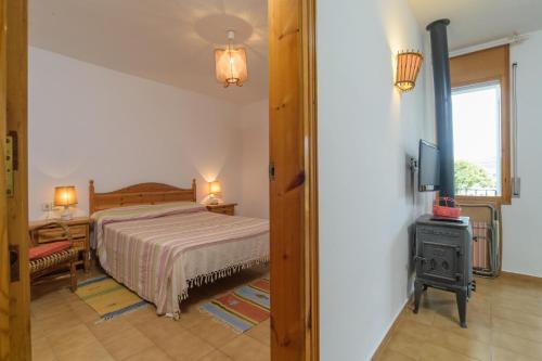 a bedroom with a bed and a tv in it at Ñ-13 CALELLA DE PALAFRUGELL 4 PAX in Calella de Palafrugell