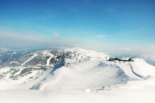 a ski lodge on the top of a snow covered mountain at Alpenhotel Ensmann in Göstling an der Ybbs