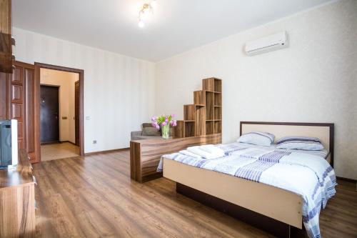 a bedroom with a bed and a tv in it at Apartment near Obolon metro station in Kyiv