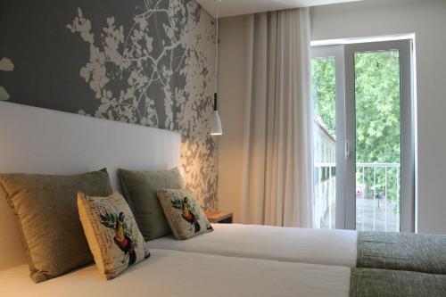 a bedroom with a bed with a large window at Barquinha Nature House in Vila Nova da Barquinha