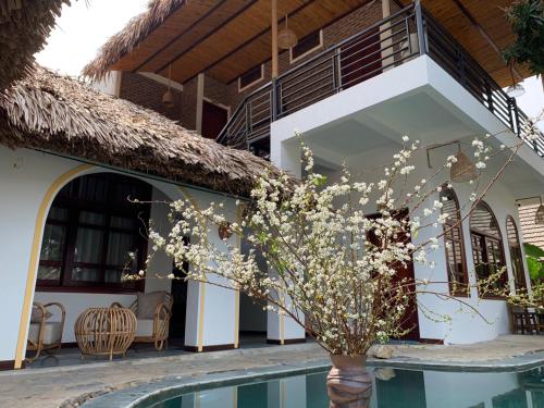 a villa with a swimming pool and a house at Mai Chau Rustic Home in Mai Chau