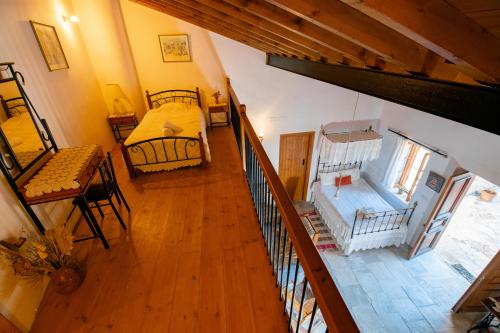 an overhead view of a room with a bed and a table at Constantias stone houses in Lofou