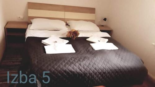 a large bed with two white towels on it at Ubytovanie na súkromí KIKA in Santovka