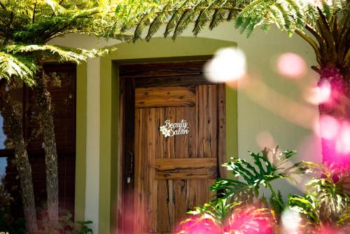 a wooden door with a sign on top of it at Villa Chad Luxury Guesthouse in Kleinmond