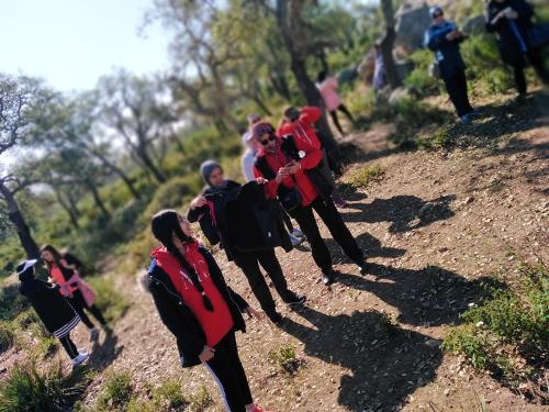 a group of people walking on a dirt road at reda land in O Ben Slimane