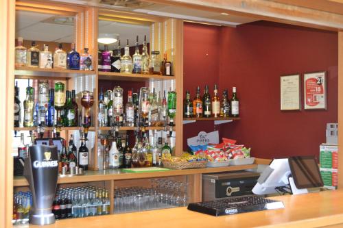 a bar with a lot of bottles of alcohol at Hinsley Hall in Leeds