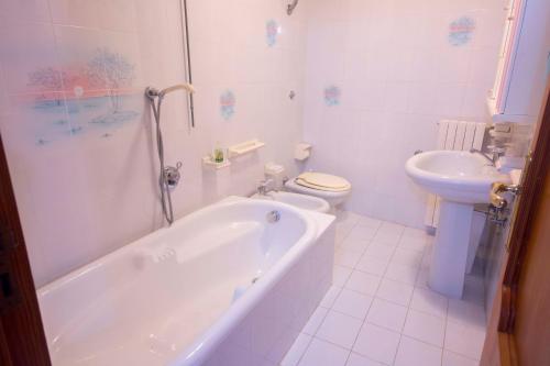 a bathroom with a tub and a toilet and a sink at CASA CHIARINA breathtaking sea view in Ravello
